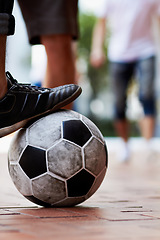 Image showing Sports, street and feet of a person for soccer, game and training for athlete. City, sneakers and legs of a man with a football for sport, exercise and urban fitness in the road while playing a match