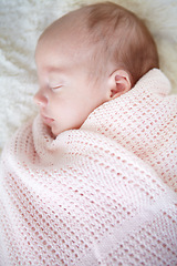 Image showing Baby, closeup and sleeping on bed, blanket and tired in profile in family home for growth, peace and comfort. Newborn infant girl, exhausted and childhood development in nursery, bedroom and house