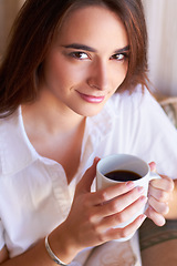 Image showing Portrait, woman drink her coffee in the morning and thinking on sofa in the living room of her home. Peace or freedom, mindfulness or relax and female person drinking hot beverage for stress relief