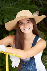 Image showing Young woman with rake, smile and gardening in portrait with nature, Spring time and blossom. Sustainability, planting and agriculture while happy female gardener is backyard and outdoor landscaping