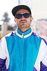 Image showing Man, fashion and face with sunglasses in a city, chill and attitude, young and stylish on blurred background. Trendy, glasses and male person with confidence, casual and cool clothes while downtown