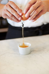 Image showing Baking, crack egg and hands with breakfast in the kitchen for health, protein and nutrition closeup. Bakery, morning and chef or person with creme brulee or food for dinner diet or restaurant cooking