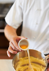 Image showing Baker, baking process and egg in batter for cake, confectionery culinary skills and person in bakery kitchen. Closeup, food and chef cooking dessert, catering industry and mixing ingredients