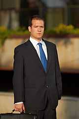 Image showing Portrait, business and man in a city, serious and executive with formal wear, finance and professional. Male person, company director and employee with a briefcase, accounting and financial adviser