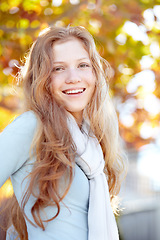 Image showing Happy, ginger and portrait of child in nature during autumn for play, outdoor fun and to relax. Smile, calm and young girl or teenager in garden or backyard during fall season for carefree childhood