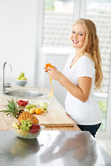 Image showing Woman portrait, eating orange and fruit for plus size health and nutrition for weight loss diet and healthy at home. Kitchen, fruits and food in a house with breakfast and nutritionist in the morning