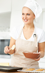 Image showing Happy woman, thinking or chef baking cookies with dough or pastry in a bakery kitchen with recipe. Food business, ideas or girl baker working in preparation of a sweet meal, dessert tray or biscuit