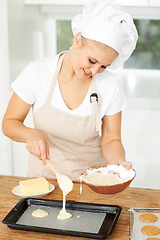 Image showing Happy woman, bakery or chef baking cookies with dough or pastry in a kitchen and is happy decorating his recipe. Food business, dessert or girl baker working in preparation of a sweet meal or biscuit