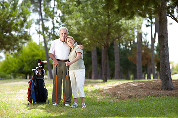 Image showing Portrait, smile or happy old couple on golf course in fitness workout, exercise or round together on grass. Embrace, healthy elderly man hugging or smiling in golfing sports game with senior woman