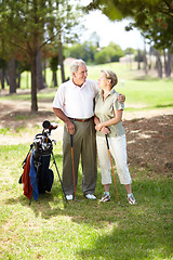 Image showing Happy old couple, love or golfers on course in fitness workout, exercise or round together on grass field. Embrace, healthy elderly man hugging or smiling in golfing sports game with senior woman