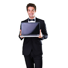 Image showing Portrait, happy and male waiter with blank screen for service in studio and white background with luxury. Butler, man and smile and menu on laptop with servant on website in mockup space with tuxedo.