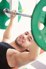 Image showing Man, portrait and weightlifting in a gym with athlete wellness and smile from workout. Fitness, happy bodybuilder and male person with weights power from strong arm muscle and training at health club