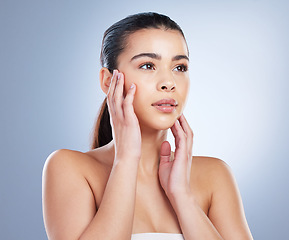 Image showing Skincare, woman and hands on face in studio for wellness, glowing skin or cosmetic satisfaction on grey background. Beauty, soft and asian lady model touching dermatology, luxury or treatment results