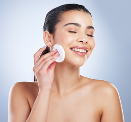 Image showing Skincare, pad and asian woman in studio for makeup removal, toner or hydration on grey background. Smile, beauty and asian lady wellness model with facial cotton for cleaning or glowing skin routine