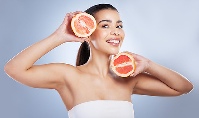 Image showing Skincare, portrait and woman with grapefruit in a studio for a natural, organic or health face routine. Beauty, self care and female model with citrus fruit for a facial treatment by gray background.