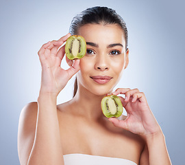 Image showing Beauty, portrait and woman with kiwi in studio for a natural, organic or health face routine. Skincare, self care and female model with fresh fruit for facial dermatology treatment by gray background