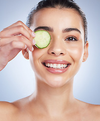Image showing Cucumber, skincare and asian woman portrait in studio happy for wellness or anti aging on grey background. Fruit. detox and lady face model smile for antioxidants, facial or beauty mask treatment
