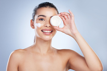Image showing Skincare, portrait and happy woman with face cream in studio for anti aging, wellness or hydration on grey background. Facial, smile and asian female model with sunscreen, lotion or beauty cosmetics