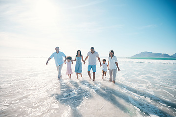 Image showing Water, beach and happy family walking at the sea or ocean bonding for love, care and happiness together. Happy, sun and parents with children or kids and grandparents on a holiday for freedom