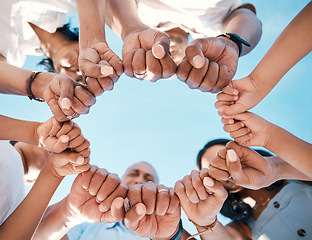 Image showing Circle, hands and fist bump by people in support of collaboration, motivation and goal from below. Fingers, team building and group with emoji for power, trust and unity, teamwork and partnership