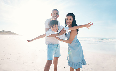 Image showing Adventure, beach and parents holding their kid on the sand by the ocean on a family vacation. Happy, smile and boy child flying and bonding with hid young mother and father on tropical summer holiday