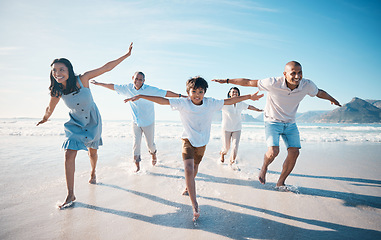 Image showing Fly, beach and happy family running on vacation together at sea or ocean bonding for love, care and happiness. Summer, sun and parents with children or kids and grandparents on holiday for freedom