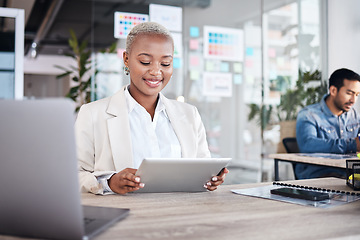 Image showing Happy woman at desk in office with tablet, laptop and reading email at design agency. Business, smile and African employee in coworking space with digital report in creative career at tech startup.