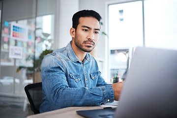 Image showing Thinking, laptop and man at desk reading email, feedback or research planning at design agency job. Business, website and computer, employee in office checking online report at tech startup workshop.