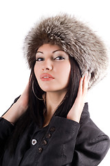 Image showing Portrait of the young woman in a fur cap. Isolated