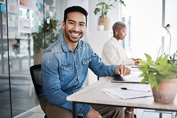 Image showing Portrait of happy man at desk in coworking space with laptop, notes and work at design agency. Business, smile and computer, employee in office with confidence in creative career at tech startup job.