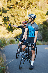 Image showing Men, forest and cycling partnership with friends, talk and helmet for training, exercise and pointing in summer. Cyclist athlete, teamwork and sightseeing on journey, workout and adventure with smile