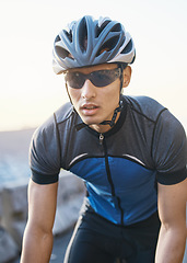 Image showing Man, mountain and cycling outdoor with sunglasses, helmet and speed for training, exercise and health in summer. Young cyclist athlete, focus and vision for race, performance and workout in sunshine