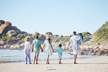 Image showing Beach, walking and grandparents, parents and children by sea for bonding, quality time and relax in nature. Family, travel and back of mom, dad and kids by ocean on holiday, vacation and adventure