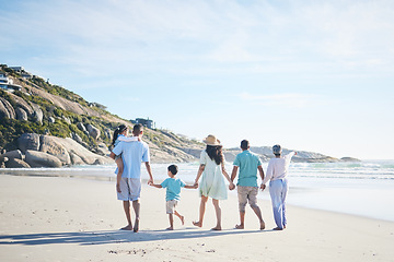 Image showing Beach, holding hands and grandparents, parents and kids for bonding, quality time and relax in nature. Family, travel and mom, dad and children walking by ocean on holiday, vacation and adventure