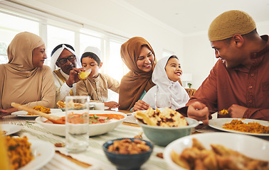 Image showing Food, happy and muslim with big family at table for eid mubarak, Islamic celebration and lunch. Ramadan festival, culture and iftar with people eating at home for fasting, islam and religion holiday