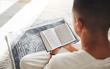 Image showing Prayer, muslim and Quran with man on living room floor for eid mubarak, God and worship. Islamic, hope and Ramadan with spiritual person praying on mat at home for faith, religion and gratitude