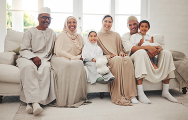 Image showing Portrait, Islam and big family on sofa for Eid with parents, grandparents and kids in home culture in Indonesia. Muslim men, women in hijab and happy children, generations on couch together in lounge