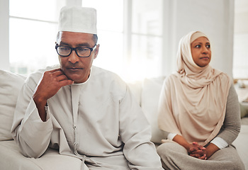 Image showing Muslim couple, fight or mature man with depression, problem or divorce conflict in home living room. Sad, crisis or marriage fail for thinking Islamic people in house stress, mental health or anxiety