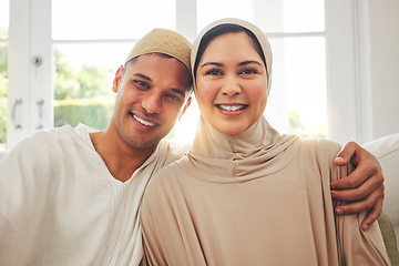 Image showing Portrait, Islam and happy couple on couch for Eid with smile, culture and love in home in Dubai. Face of Muslim man, woman in hijab and happiness in marriage on sofa, together in respect and religion