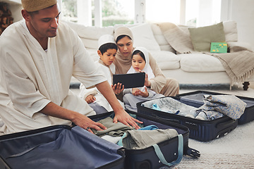 Image showing Travel, packing and Muslim family with suitcase in living room for holiday, vacation and religious trip. Home, luggage and parents and children with tablet and bag for journey, adventure and tourism