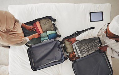 Image showing Travel, bedroom and Muslim couple with suitcase packing for holiday, vacation and religious trip. Home, luggage and above of man and woman with clothes in bag for journey, adventure and tourism