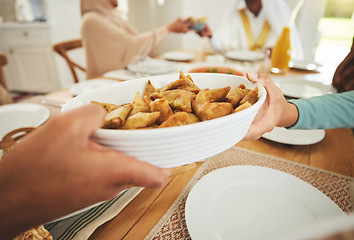 Image showing Food, samosa and muslim with hands of family at table for eid mubarak, Islamic celebration and lunch. Ramadan festival, culture and iftar with closuep of people at home for fasting, islam or religion