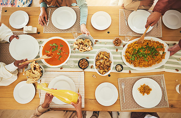 Image showing Food, Eid Mubarak and above of family eating at table for Islamic celebration, festival and lunch together. Ramadan, religion and hands with meal, dish and cuisine for fasting, holiday and culture