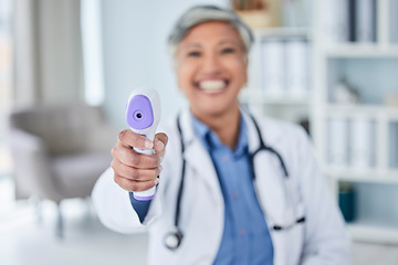 Image showing Temperature, happy or doctor with thermometer for healthcare in hospital clinic or medical center. Senior woman blur, infrared laser test or mature nurse screening or checking fever, virus or disease