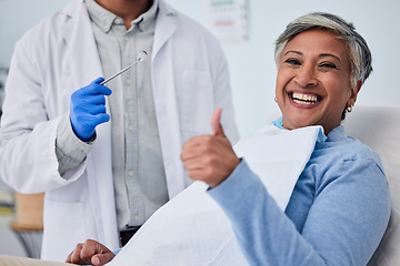 Image showing Happy woman, teeth and thumbs up for dentist in dental care, appointment or checkup at clinic. Senior female person smile with like emoji or yes sign in tooth whitening, cleaning mouth or gum care