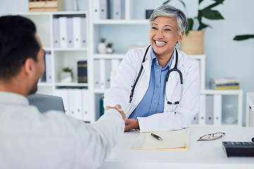 Image showing Happy woman, doctor and handshake for meeting, hiring or partnership in consultation at the hospital. Senior female person, medical or healthcare professional shaking hands in interview or recruiting