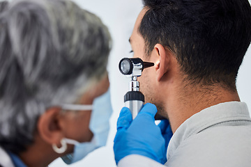 Image showing Woman, doctor and checking patient ear for flu, exam or healthcare appointment at the hospital. Female person or medical professional with protection looking at ill or sick man with flu at the clinic