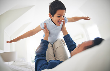 Image showing Airplane, game and happy boy child with father on a bed with love, bonding and having fun in their home. Flying, playing and face of kid smile with parent in a bedroom with fantasy, plane or lift