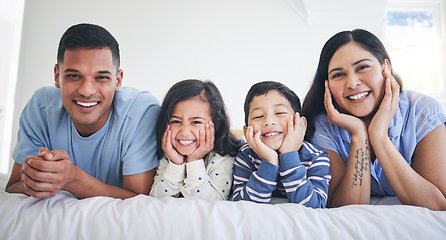 Image showing Happy family, portrait and kids with parents on a bed relax, excited and bonding in their home. Face, smile and children with mother and father in bedroom for weekend, chilling and waking up playful