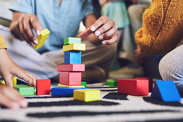 Image showing Hands, building blocks and color, learning and development with people at home playing games with toys. Relax on living room floor, parents and children with education activity, family and bonding